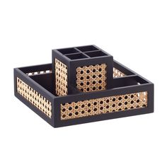 two black and gold trays sitting on top of each other, one with holes in the middle