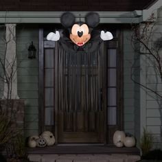 a mickey mouse door decoration with pumpkins