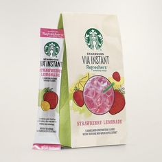 a starbucks bag with strawberries and lemonade on the front is next to a carton of strawberry lemonade