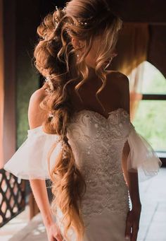 a woman with long hair in a wedding dress