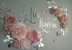 the wall is decorated with pink flowers and silver foil lettering that says, julia llana