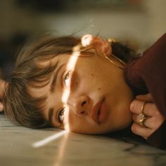 a woman laying on the floor with her eyes closed