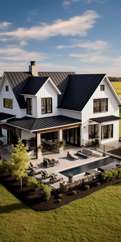 an aerial view of a house with a pool in the front yard and lawn area