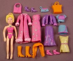 a barbie doll with lots of clothes and shoes on the floor next to it's contents