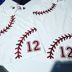 two baseball jerseys with the number 12 and 12th on them are sitting on a table