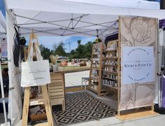 an outdoor market tent with various items for sale