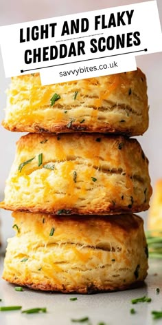 three biscuits stacked on top of each other with the words light and flaky cheddar scones above them