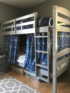 bunk beds with blue and white bedding in a room