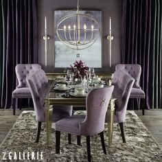 a dining room with purple chairs and a chandelier