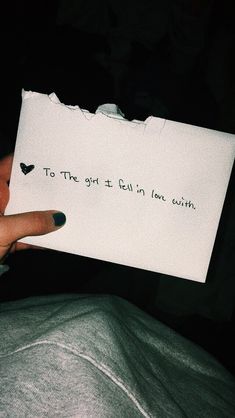 someone holding up a piece of paper with writing on it that says to the girl i fell in love with