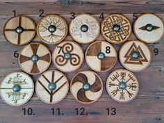 a wooden clock with twelve different designs on it's face and numbers in the middle