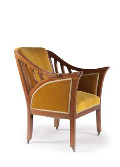 an old fashioned wooden chair with yellow upholstered fabric on the armrests