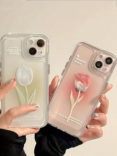 two women holding up their iphone cases with flowers on them