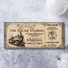 a ticket for the polar express is displayed on a table with ornaments and snowflakes