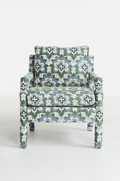 a green and white patterned chair on a white background