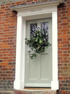 a white door with a wreath on it