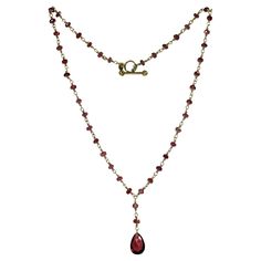 This gorgeous Tiffany & Co. pendant necklace features briolette beads crafted in rhodolite garnet and completed with an 18k white gold clasp. Made in United States circa 1990s. Measurements: 0.35" (9mm) width, 16" (40.6cm) length. Excellent condition. Garnet Beaded Necklace, 18k Gold Necklace, Rhodolite Garnet, Tiffany And Co, Jewelry Inspo, Drop Necklace, Tiffany & Co., Garnet, Beaded Jewelry