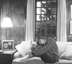 a woman sitting on top of a couch in a living room