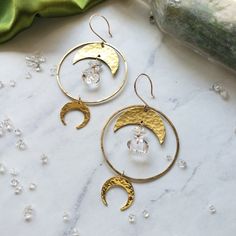 Hammered brass hoops and Moons featuring delicate Diamond Quartz Beads Simple and solid enough for daily wear 2" diameter. 3" long Each stone is unique and may vary slightly in color/shape from stone to stone. One of a kind handle with care Made with love by Elizabeth Cline in San Francisco, CA Wrapped in Dreamers of Dreams travel/gift bag Gold Hoop Jewelry With Moon Phase Detail, Everyday Handmade Crescent Jewelry, Festival Brass Wire Wrapped Hoop Earrings, Bohemian Brass Earrings With Moon Phase Detail, Bohemian Brass Moon Phase Earrings, Bohemian Brass Earrings With Moon Phase, Everyday Handmade Half Moon Jewelry, Everyday Brass Jewelry With Moon Charm, Handmade Crescent Brass Jewelry