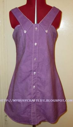 a woman's purple shirt dress on a mannequin