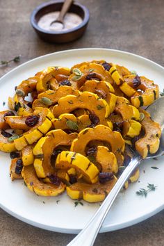 a white plate topped with squash and raisins