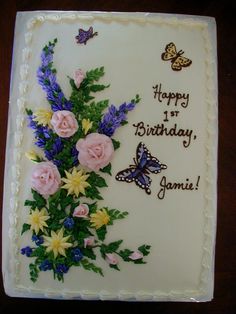 a birthday cake with flowers and butterflies on it