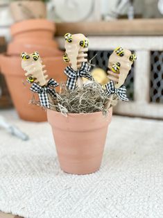 a potted plant with fake bees on it