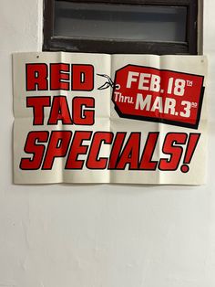 red tag specials stickers on a white wall