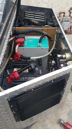 the inside of a toolbox with tools in it and other items on the ground