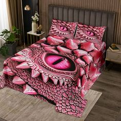 a bed with pink dragon designs on it