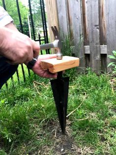 a man is holding a hammer in his hand