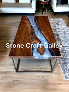 a wooden table sitting on top of a hard wood floor next to two couches