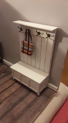 a white bench with a purse hanging on it