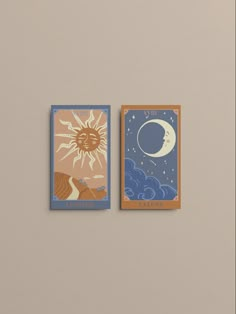 two cards with sun and moon on them are hanging on the wall next to each other