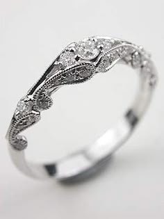 a white gold ring with an intricate design