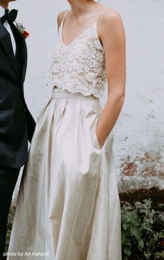 a young man and woman standing next to each other in formal wear, posing for the camera