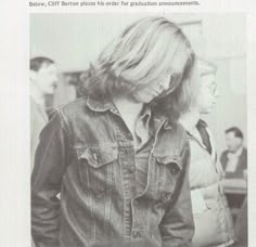 an old photo of a woman wearing a jean jacket