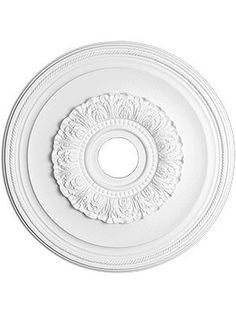 a white ceiling medallion with an ornate design