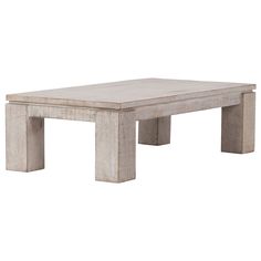 a white coffee table sitting on top of a hard wood floor covered in cement blocks