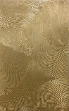 an abstract gold painting with wavy lines