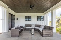 an outdoor living area with wicker furniture