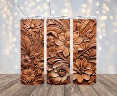 three wooden panels with flowers and leaves on them, one is made out of wood