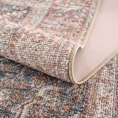 a close up view of an area rug with different colors and patterns on the carpet