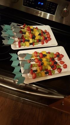 two trays filled with fruit sitting on top of an oven burner next to each other