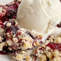 a white plate topped with fruit cobbler and ice cream