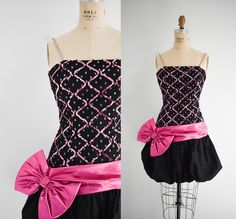 "Description: 1980s black taffeta mini cocktail dress. Synthetic. The bodice is covered with polka dot tulle and pink sequins on the front. It has a drop waist fit with a large metallic pink bow and sash. The bubble skirt has some stiff lining. It has rhinestone straps. Back nylon zipper and hook and eye. Condition: In great condition, with no stains or holes. The zipper closes all the way in the back, it was just too small for my form. Designer: Nadine Stated size: 7/8  Measurements:  Armpit to armpit: 14.5\" Bodice length: 20 - 22\"  Strap length: 13\" Overall length: 33.5\" Waist: 24\"  Hips: up to 38\" ---> If you need an order shipped by a particular date or shipped via a quicker method, please ask PRIOR to purchase to see if we can accommodate that request. Visit the rest of our shop Pink And Black Fashion Aesthetic, Pink Fashion Designer Aesthetic, Black And Pink Outfit, Pink And Black Dress, Hot Pink Fashion, Black And Pink Dress, 2000s Clothes, Bubble Dress