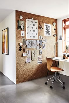 a home office with a cork board wall