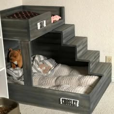 a child's bed made out of pallets with a stuffed animal in it