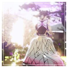 the back of a woman's head with a butterfly on her hat, and trees in the background