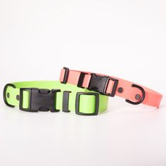 two neon colored dog collars with black buckles on each side, one pink and one green